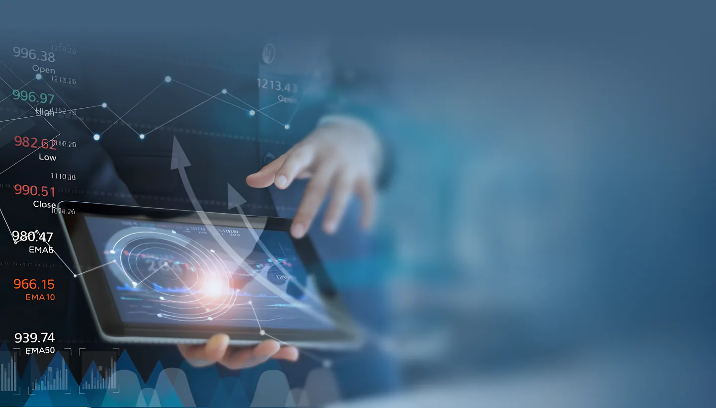 Executive holding a tablet surrounded by financial market data