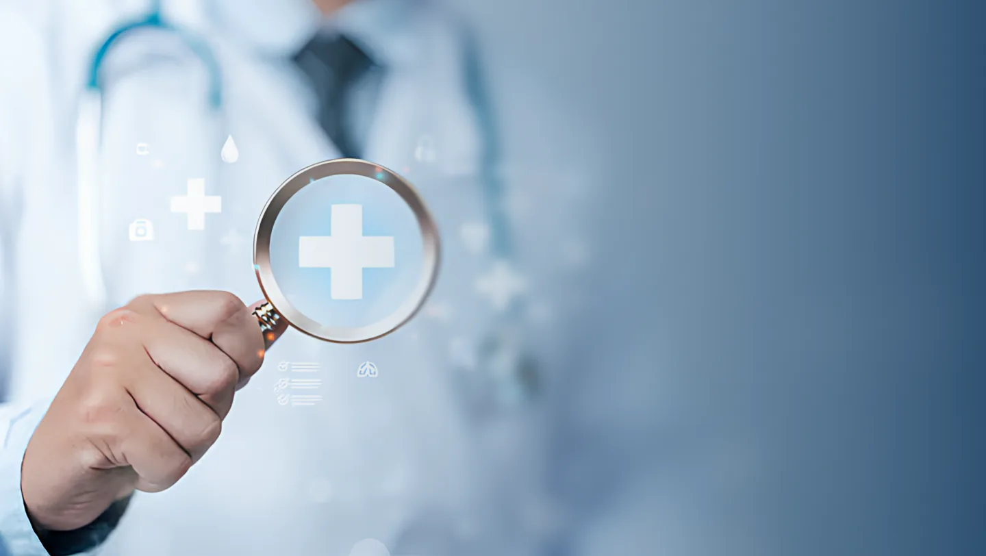 Doctor holding a magnifying glass over a medical cross